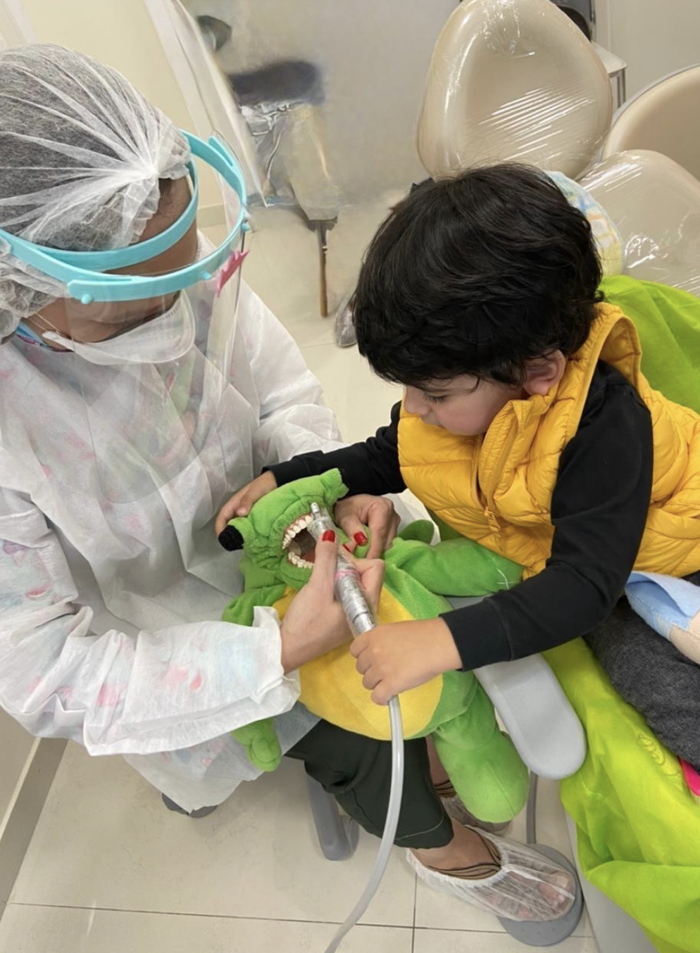 Criança manuseando instrumentos em boneco antes do atendimento